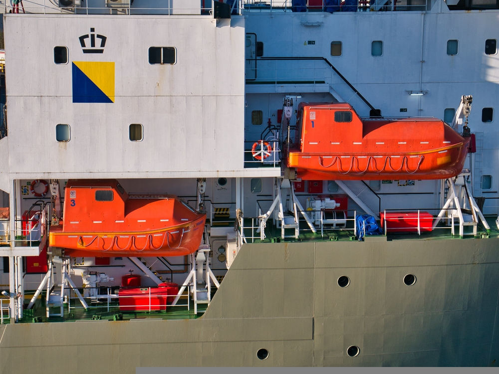 Two orange, high visibility, launch ready marine lifeboats, suspended between white launch davits on a North Sea support vessel in Aberdeen Harbour. Labour has confirmed its plans to block all North Sea oil and gas projects