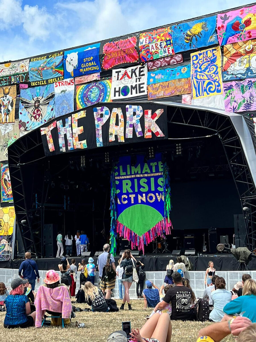 Image of Glastonbury stage covered in climate change flags and banners