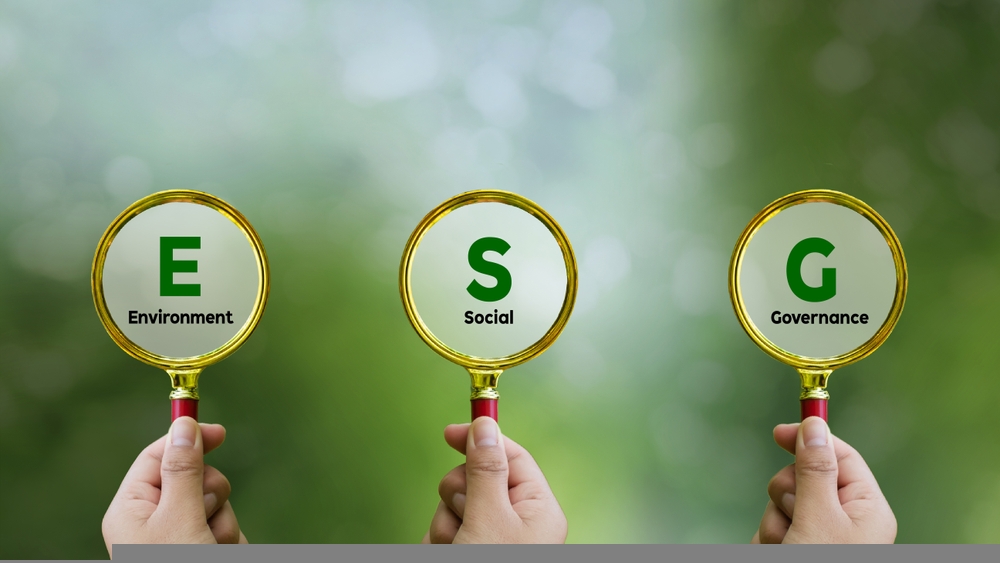 Words ESG. on magnifier glass with green backgroud. Concept of environmental, social and governance. Sustainable and ethical business. account the environment, society and corporate governance.