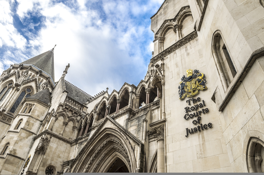 The Victorian Gothic style main entrance to the The Royal Courts of Justice public building in London, UK, opened in 1882. UK government faces court