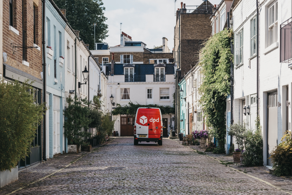 DPD Delivery van driving past mews houses in Paddington, London, UK. DPDgroup is an international parcel delivery service with an extensive network in UK.