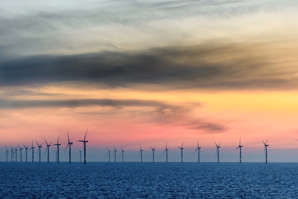 Sunset with orange sky together with the offshore wind farm: Google announces largest offshore wind project to date