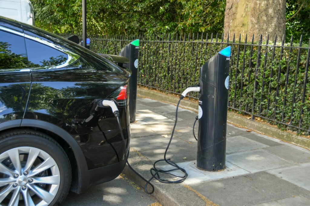 Electric vehicle plugged in. Zemo Partnership. Backed by 21 businesses including Ikea, Virgin Media O2 and Currys are urging the government to improve EV charging infrastructure.