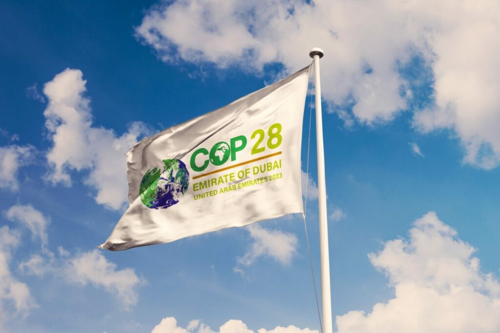 COP28 flag. A COP28 deal to help the world’s poorest and most vulnerable countries pay for the impact of climate change called 'vital first step'.