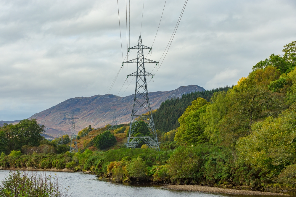 Electricity pylons running beside the River Conon in Strathconon, a remote glen in the Scottish Highlands, providing power to residents and businesses in the glen. Copy space. Horizontal. SP Energy Networks