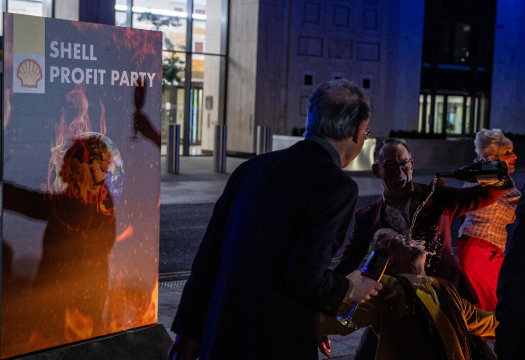 Greenpeace activists disguised as Shell executives drink champagne and dance around a burning sign reading ‘Your Future’ at a mock party outside the Shell headquarters as the company made its profit announcement in 2023. The action is designed to highlight the contradiction of fossil fuel companies posting massive profits made during a year where extreme weather linked to climate change wreaked havoc around the world.Campaigners have slammed Shell for upping shareholder dividends as the firm announced £22.4 billion worth of profit for 2023, which is better than anticipated.