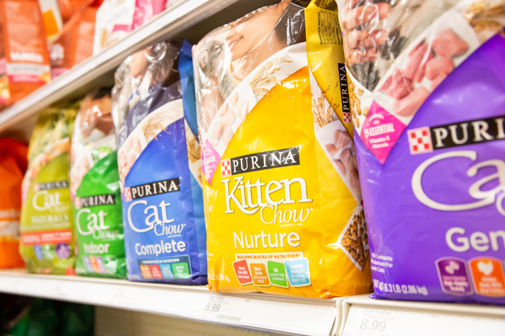 A view of several packages of Purina Kitten Chow on display at a local grocery store.